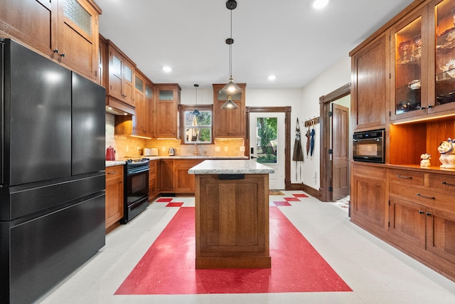 933 W Pershing St, Springfield, MO 65806 - kitchen featuring black appliances, brown cabinetry, tasteful backsplash, recessed lighting, and a center island