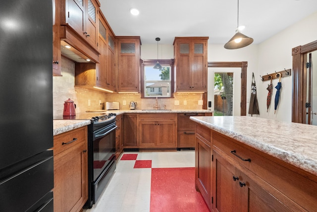 933 W Pershing St, Springfield, MO 65806 - kitchen featuring black appliances, brown cabinetry, light floors, hanging light fixtures, and tasteful backsplash