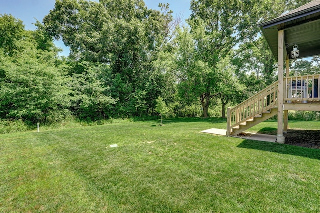 653 W Arbor Glenn Dr, Nixa, MO 65714 - view of grassy yard with stairway, view of wooded area, and a deck