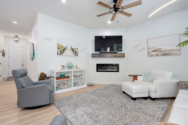 653 W Arbor Glenn Dr, Nixa, MO 65714 - living room featuring wood finished floors, a ceiling fan, recessed lighting, and a fireplace