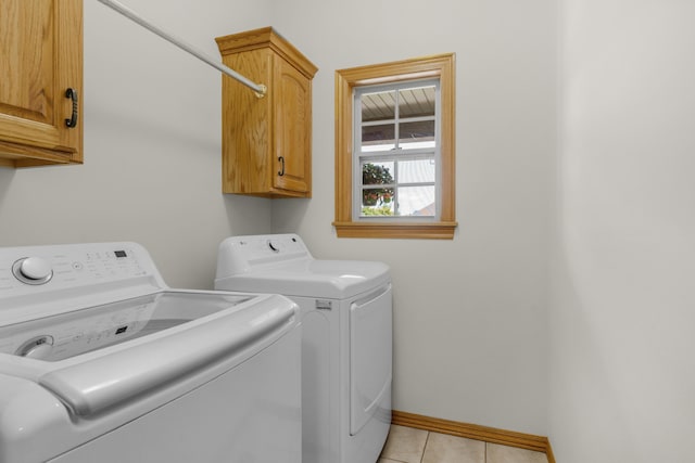1190 E Headley St, Springfield, MO 65803 - washroom with cabinet space, washer and dryer, and light tile patterned floors