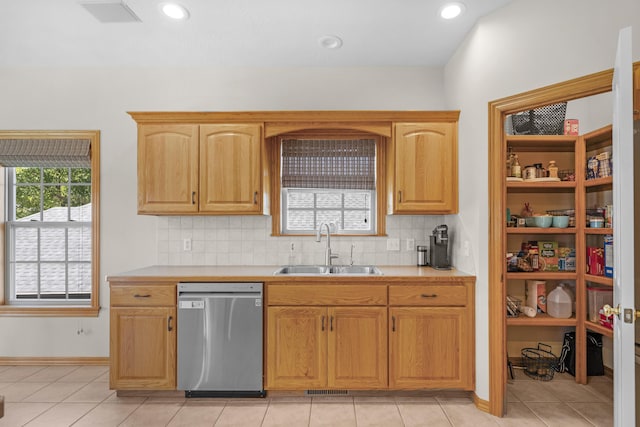 1190 E Headley St, Springfield, MO 65803 - kitchen featuring stainless steel dishwasher, light countertops, tasteful backsplash, light tile patterned floors, and recessed lighting