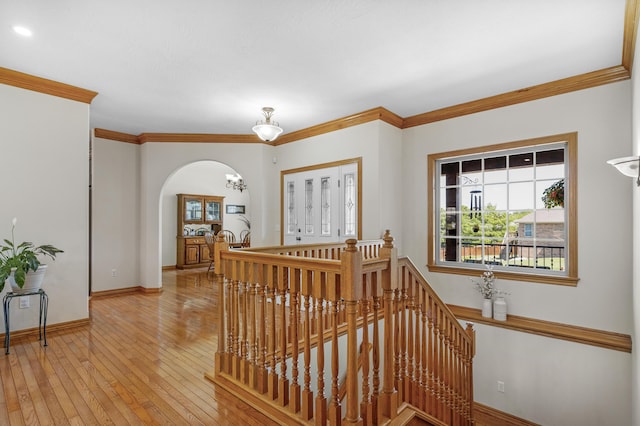 1190 E Headley St, Springfield, MO 65803 - corridor with an upstairs landing, crown molding, light wood-style floors, and arched walkways