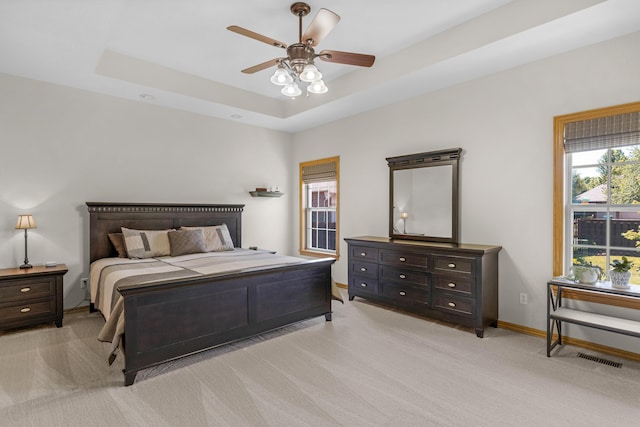 1190 E Headley St, Springfield, MO 65803 - bedroom featuring light colored carpet, a raised ceiling, and a ceiling fan