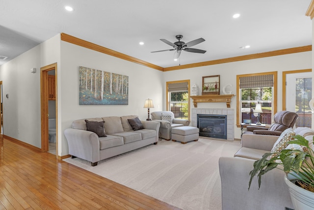 1190 E Headley St, Springfield, MO 65803 - living room with plenty of natural light, light wood-style flooring, a tiled fireplace, recessed lighting, and ornamental molding