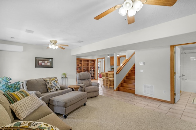 1190 E Headley St, Springfield, MO 65803 - living room with a ceiling fan, light tile patterned floors, a wall mounted air conditioner, stairway, and light carpet