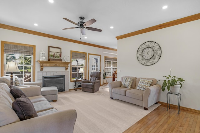 1190 E Headley St, Springfield, MO 65803 - living room with recessed lighting, ornamental molding, a ceiling fan, a tiled fireplace, and light wood-style flooring
