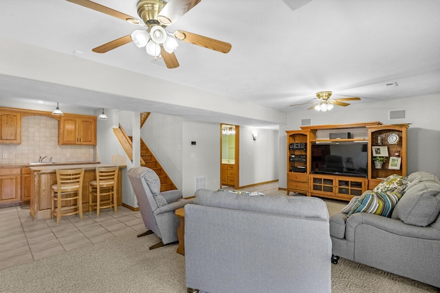 1190 E Headley St, Springfield, MO 65803 - living area with a ceiling fan, stairway, light tile patterned floors, and light colored carpet