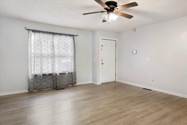 1219 N Clifton Ave, Springfield, MO 65802 - unfurnished room featuring ceiling fan, wood finished floors, and a textured ceiling