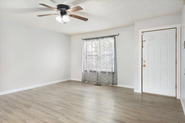 1219 N Clifton Ave, Springfield, MO 65802 - spare room with a ceiling fan, a textured ceiling, and wood finished floors