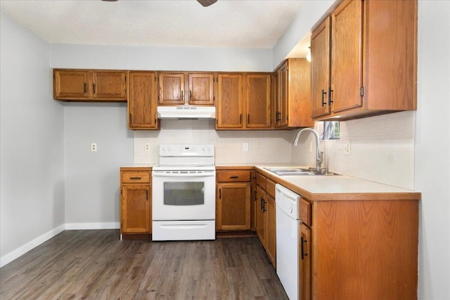 1219 N Clifton Ave, Springfield, MO 65802 - kitchen featuring white appliances, under cabinet range hood, brown cabinets, and dark wood finished floors
