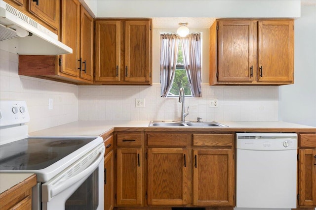 1219 N Clifton Ave, Springfield, MO 65802 - kitchen featuring white appliances, under cabinet range hood, light countertops, backsplash, and brown cabinetry