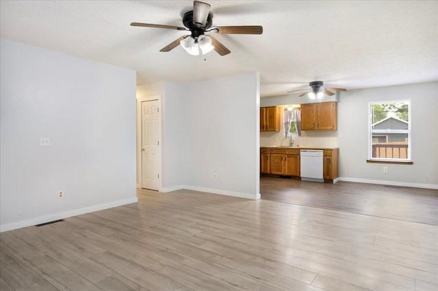 1219 N Clifton Ave, Springfield, MO 65802 - unfurnished living room featuring a ceiling fan, light wood-style floors, and a textured ceiling