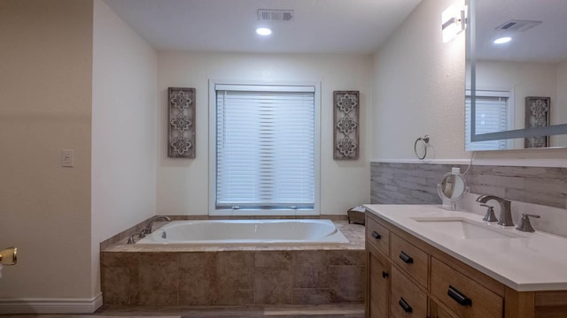 24 Oniatara Ln, Cherokee Village, AR 72529 - bathroom with a bath, vanity, and tasteful backsplash