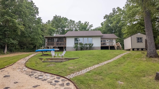 24 Oniatara Ln, Cherokee Village, AR 72529 - back of property featuring a sunroom, a storage shed, a yard, and a wooden deck