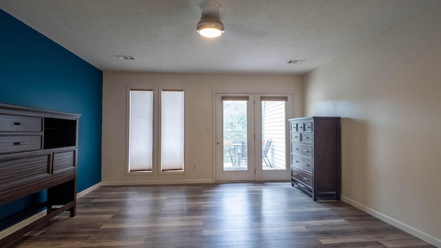 24 Oniatara Ln, Cherokee Village, AR 72529 - unfurnished living room with dark wood-style flooring and baseboards