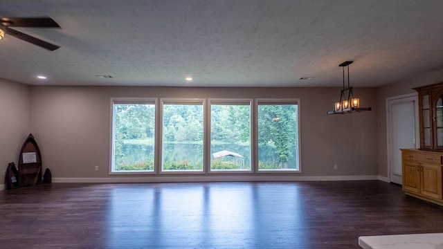 24 Oniatara Ln, Cherokee Village, AR 72529 - unfurnished living room with dark wood-style floors, ceiling fan, recessed lighting, and a chandelier