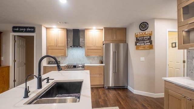 24 Oniatara Ln, Cherokee Village, AR 72529 - kitchen featuring stainless steel appliances, wall chimney exhaust hood, dark wood-type flooring, tasteful backsplash, and light brown cabinetry