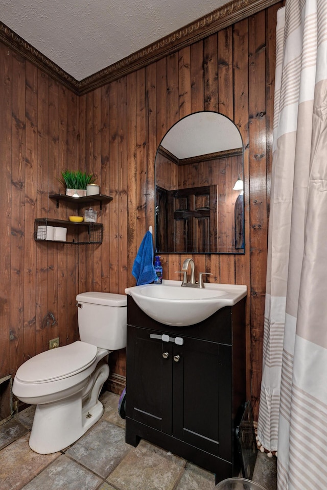 207 W Grand, Neosho, MO 64850 - bathroom with wooden walls, vanity, a shower with shower curtain, stone finish flooring, and a textured ceiling