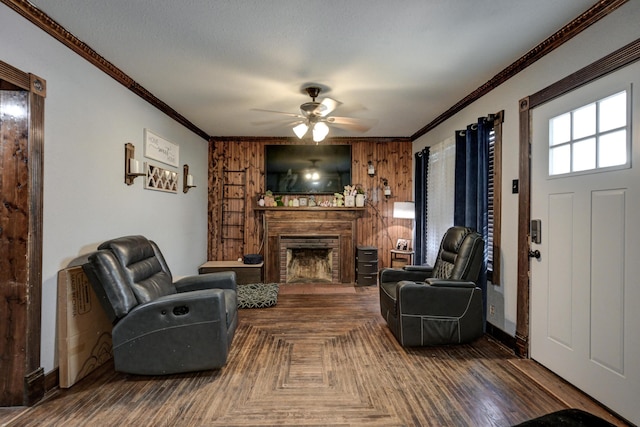 207 W Grand, Neosho, MO 64850 - living room featuring ornamental molding, a ceiling fan, a fireplace, and wood walls