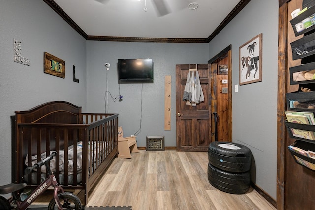 207 W Grand, Neosho, MO 64850 - bedroom with crown molding, wood finished floors, a nursery area, and a ceiling fan