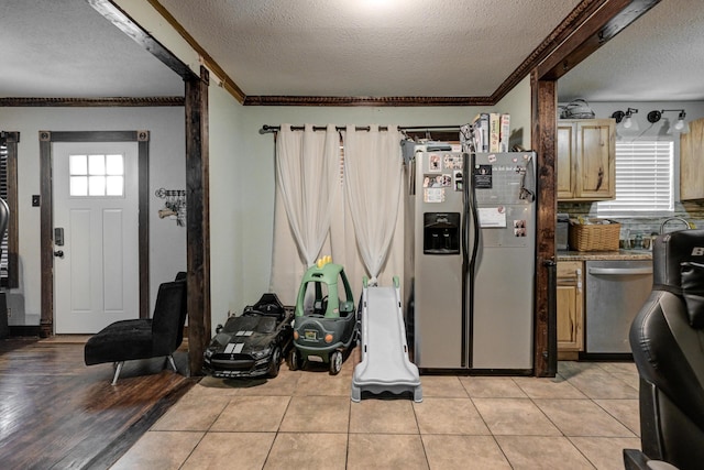 207 W Grand, Neosho, MO 64850 - kitchen with stainless steel appliances, a textured ceiling, and crown molding
