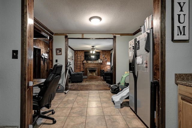 207 W Grand, Neosho, MO 64850 - home office featuring ceiling fan, a fireplace, a textured ceiling, ornamental molding, and a textured wall