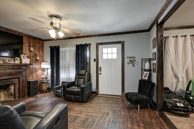 207 W Grand, Neosho, MO 64850 - living room with crown molding, a textured ceiling, a fireplace, and ceiling fan