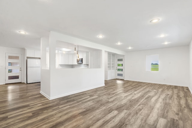 5295 E Farm Road 138, Springfield, MO 65809 - unfurnished living room with dark wood-type flooring, recessed lighting, and built in features