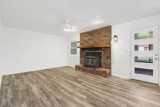 5295 E Farm Road 138, Springfield, MO 65809 - unfurnished living room featuring wood finished floors, ceiling fan, and a fireplace