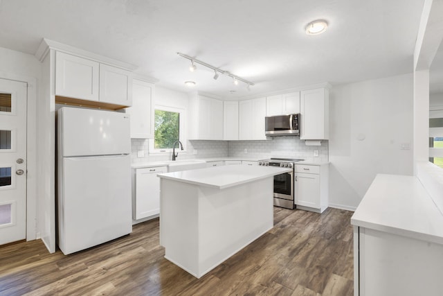 5295 E Farm Road 138, Springfield, MO 65809 - kitchen featuring appliances with stainless steel finishes, white cabinetry, and decorative backsplash
