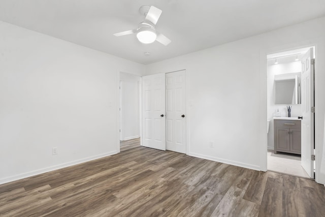 5295 E Farm Road 138, Springfield, MO 65809 - unfurnished bedroom featuring wood finished floors, a closet, ensuite bath, and ceiling fan