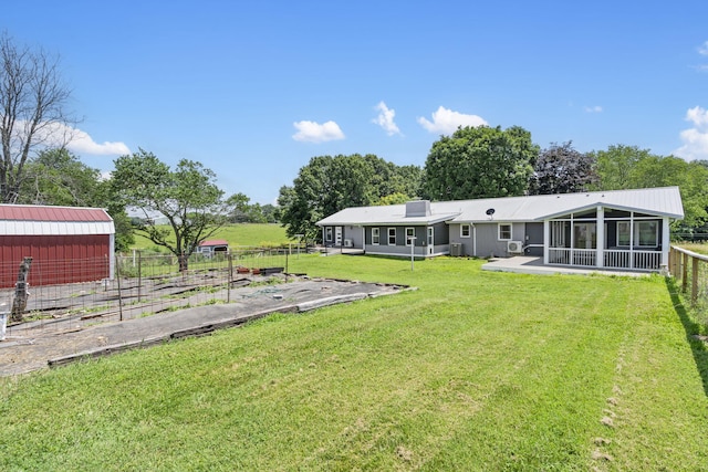 5295 E Farm Road 138, Springfield, MO 65809 - view of yard featuring a sunroom, a vegetable garden, and an outdoor structure