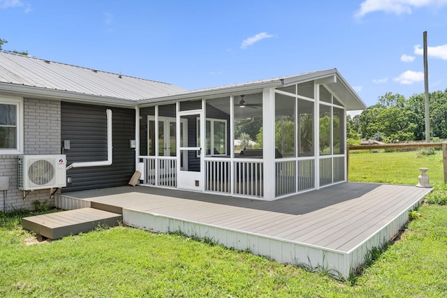 5295 E Farm Road 138, Springfield, MO 65809 - rear view of house featuring a sunroom, a wooden deck, a metal roof, and a yard