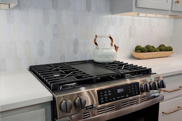 5030 E Swale Ct, Springfield, MO 65802 - kitchen view of stainless steel gas range oven, decorative backsplash, and light countertops