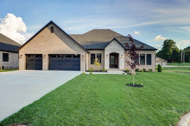 5030 E Swale Ct, Springfield, MO 65802 - view of front of house featuring a garage, a front lawn, driveway, brick siding, and roof with shingles