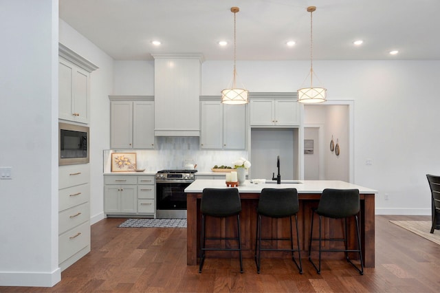 5030 E Swale Ct, Springfield, MO 65802 - kitchen with gas range, built in microwave, an island with sink, tasteful backsplash, and light countertops