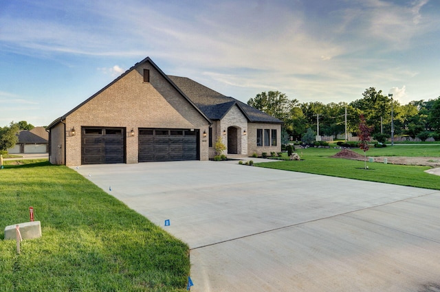 5030 E Swale Ct, Springfield, MO 65802 - french country inspired facade featuring concrete driveway, an attached garage, a front yard, and brick siding