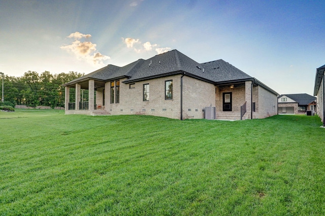 5030 E Swale Ct, Springfield, MO 65802 - rear view of house featuring brick siding, a lawn, a shingled roof, and crawl space