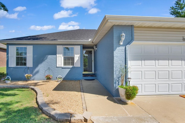 855 Birch St, Nixa, MO 65714 - view of front facade featuring a garage, driveway, and a shingled roof