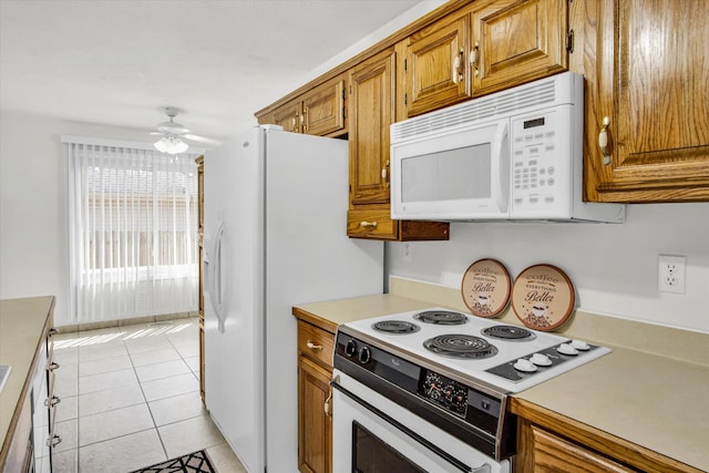 855 Birch St, Nixa, MO 65714 - kitchen featuring white appliances, ceiling fan, brown cabinetry, and light countertops