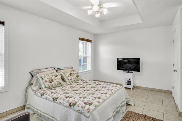855 Birch St, Nixa, MO 65714 - bedroom featuring tile patterned floors, a ceiling fan, and a tray ceiling