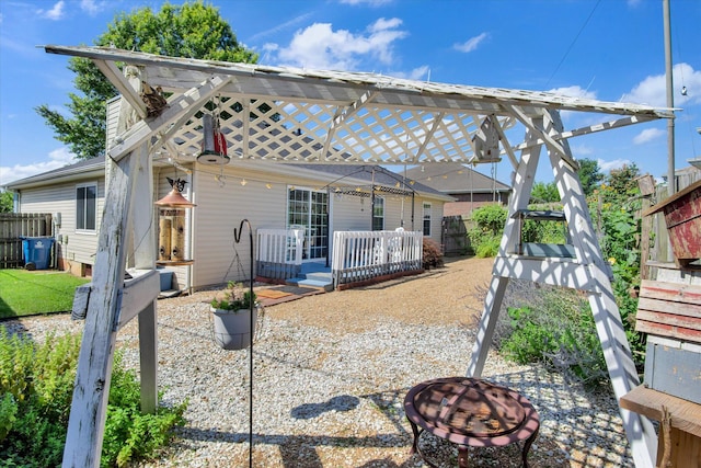 855 Birch St, Nixa, MO 65714 - rear view of house featuring a fire pit and a wooden deck