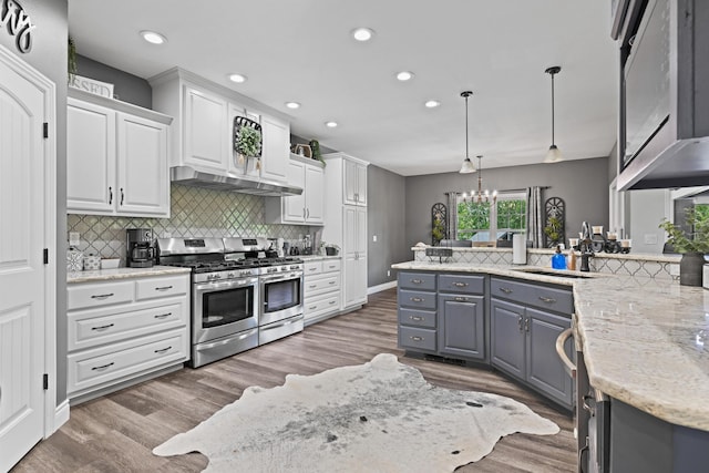 13030 County Lane 228, Oronogo, MO 64855 - kitchen with stainless steel gas range oven, white cabinets, recessed lighting, decorative backsplash, and a chandelier