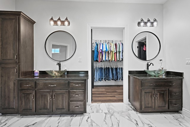 13030 County Lane 228, Oronogo, MO 64855 - bathroom featuring two vanities, marble look tile flooring, and a walk in closet