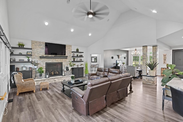 13030 County Lane 228, Oronogo, MO 64855 - living room with a ceiling fan, a chandelier, high vaulted ceiling, wood finished floors, and a fireplace