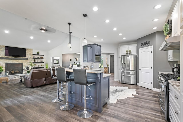 13030 County Lane 228, Oronogo, MO 64855 - kitchen with stainless steel appliances, a peninsula, open floor plan, a breakfast bar area, and light stone counters