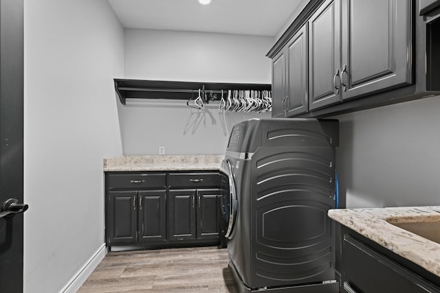 13030 County Lane 228, Oronogo, MO 64855 - laundry area featuring cabinet space, washer / clothes dryer, and light wood-type flooring