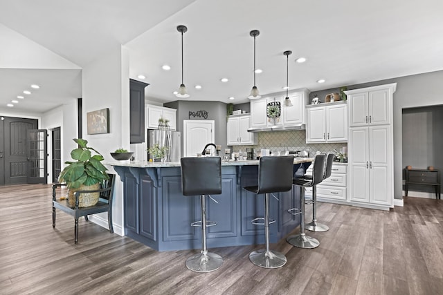 13030 County Lane 228, Oronogo, MO 64855 - kitchen featuring freestanding refrigerator, wood finished floors, a peninsula, white cabinets, and recessed lighting