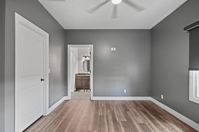 13030 County Lane 228, Oronogo, MO 64855 - unfurnished bedroom with wood finished floors, ensuite bathroom, and a ceiling fan